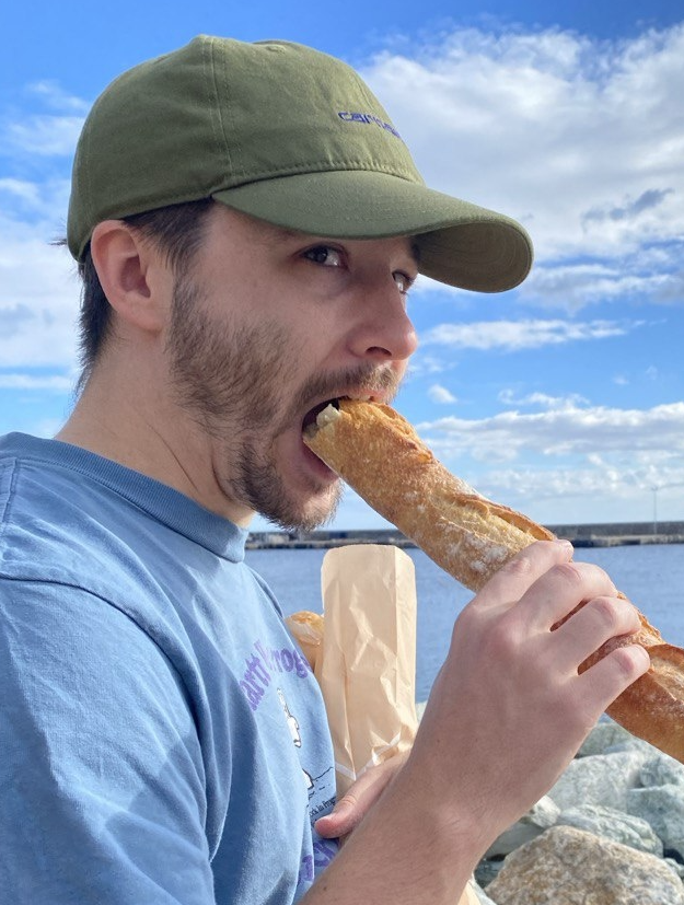 photo of the speaker eating a baguette